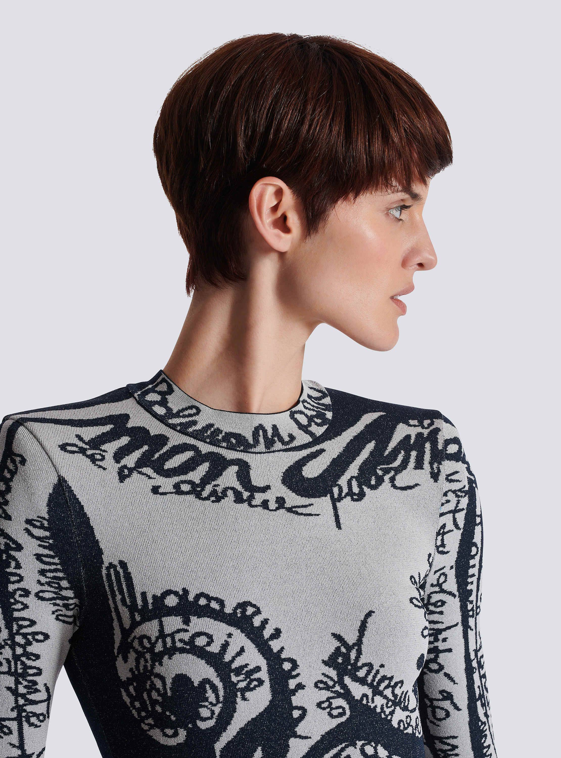 Short embroidered dress with body motif