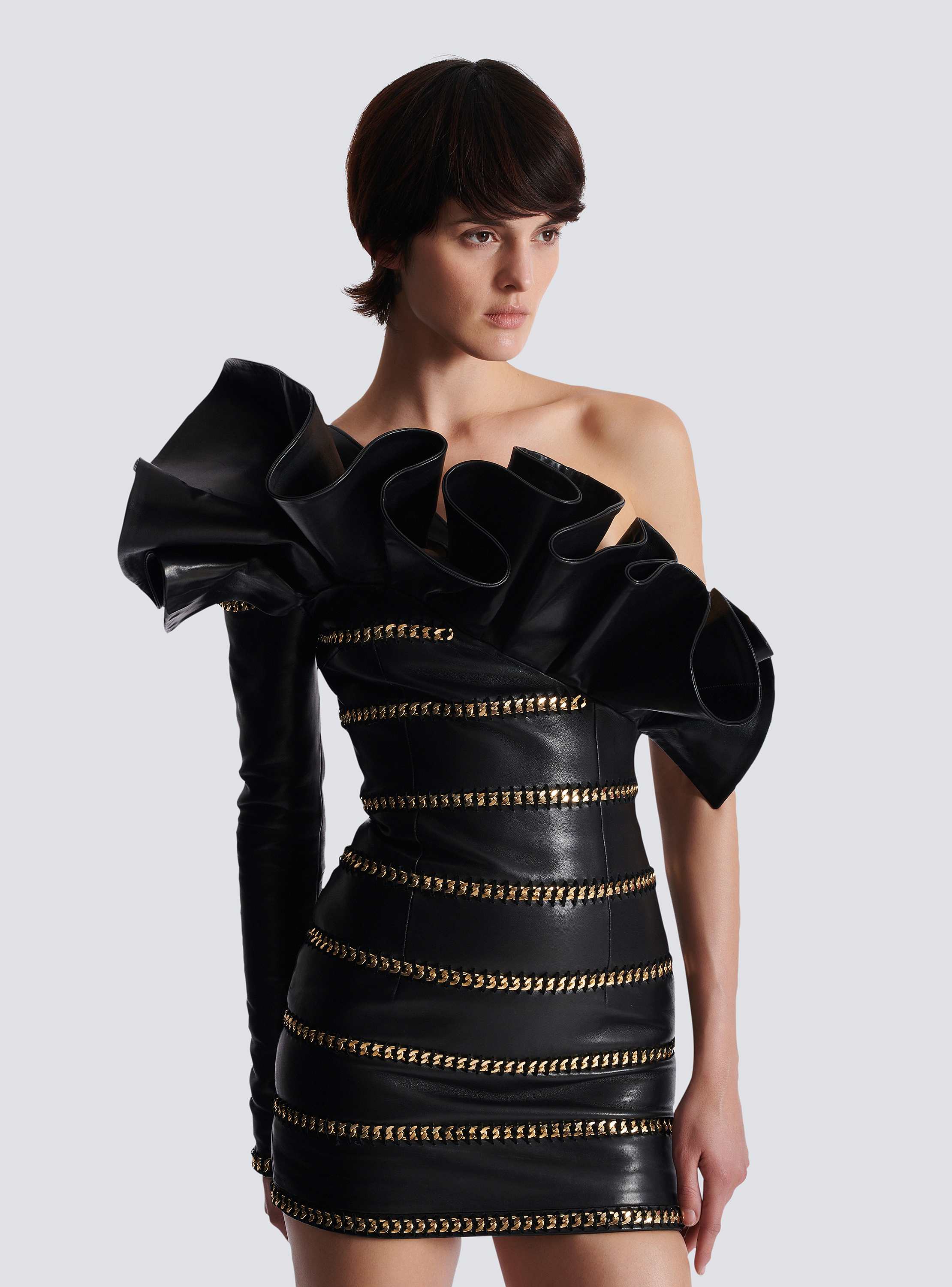 Asymmetric leather bodycon dress with chains