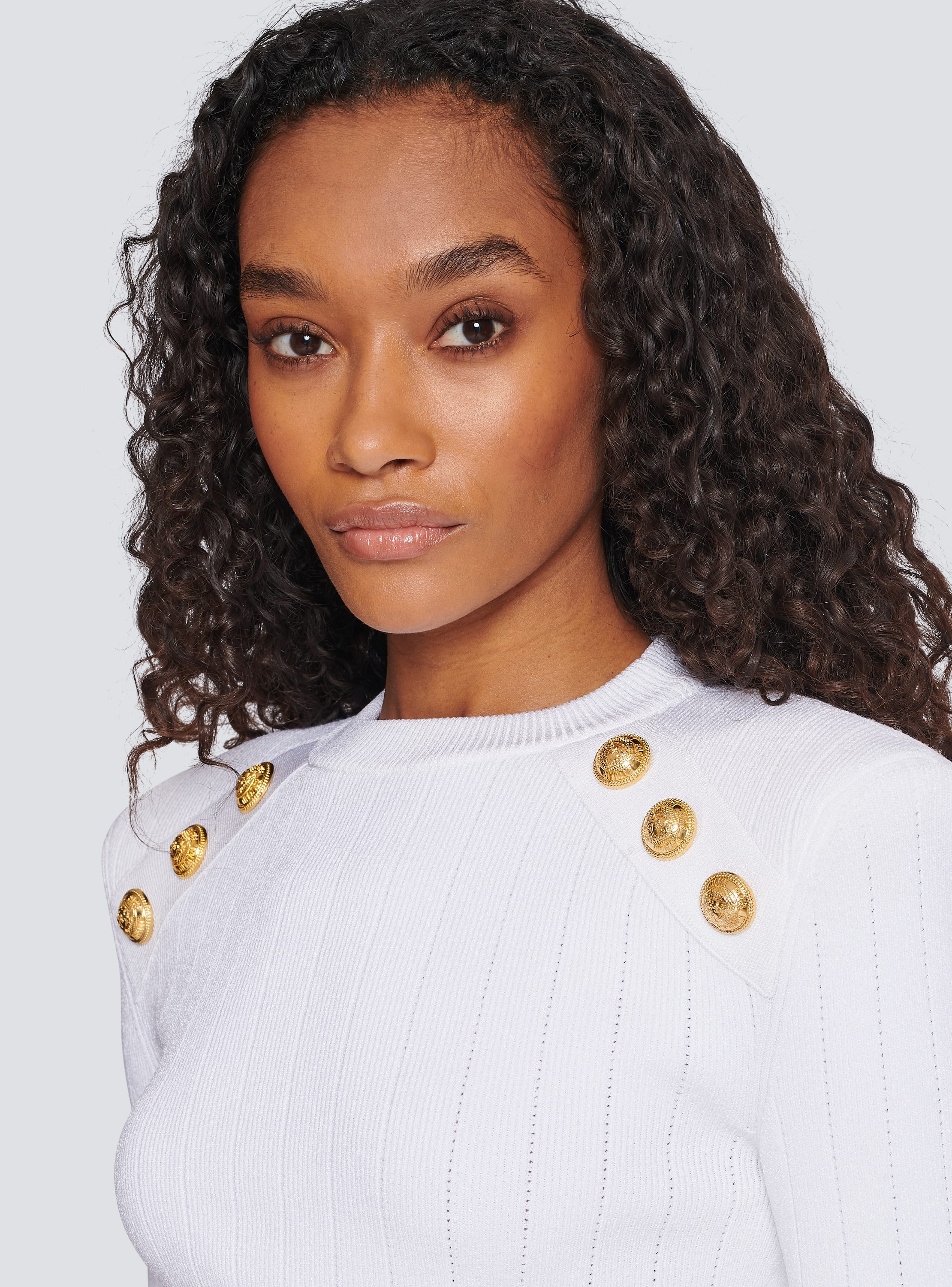 Jumper with gold outlet buttons